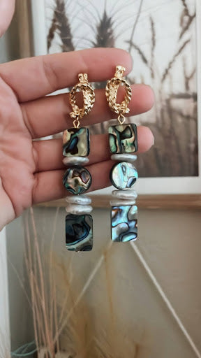 Shimmer in the sky with our Abalone Skies Earrings! These 14k gold-plated stainless-steel findings showcase stunning abalone and freshwater pearls for a unique, ocean-inspired look. Let your style shine with these playful and elegant earrings.